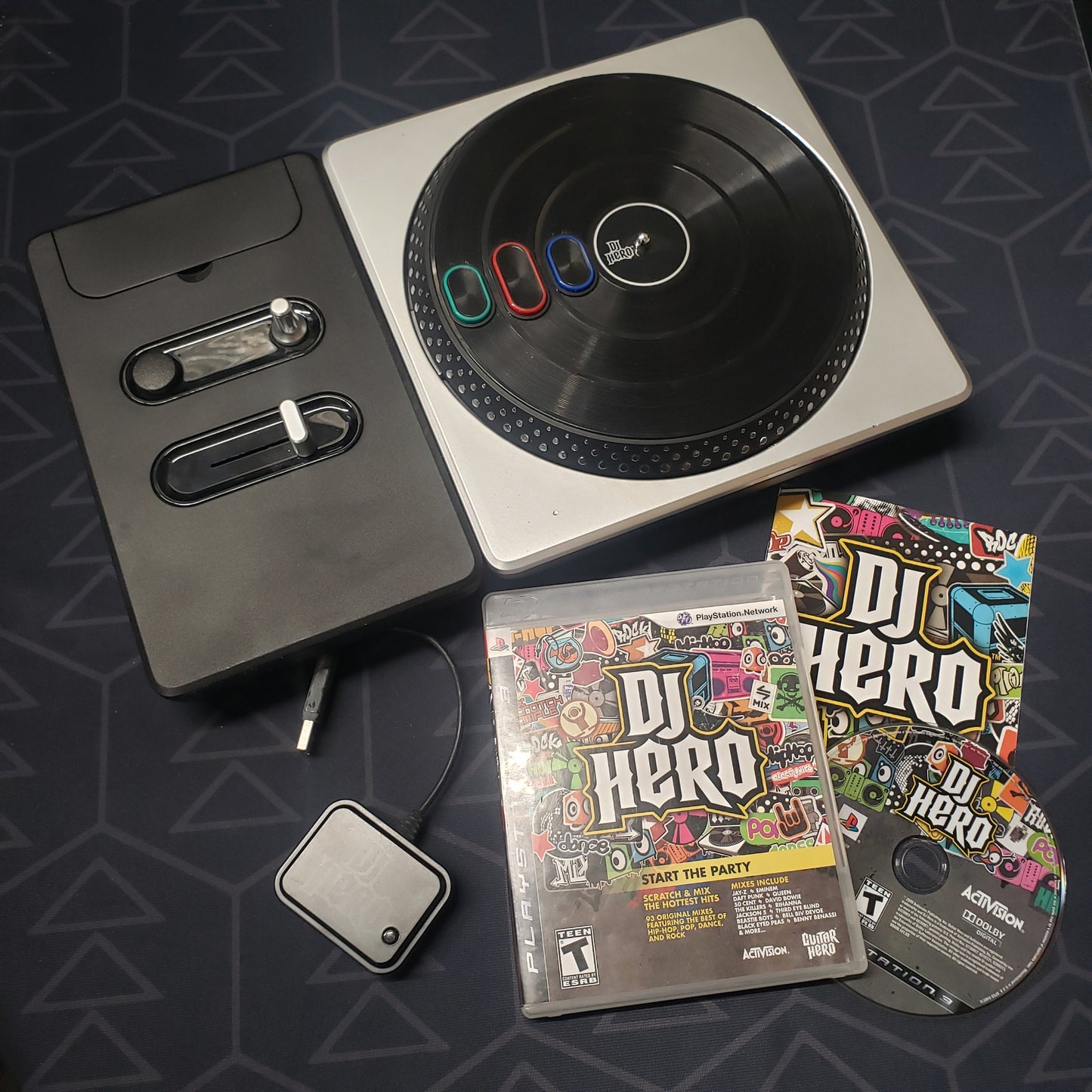 Image shows the case, manual, disc, turntable controller & wireless dongle for the video game DJ Hero for Playstation 3