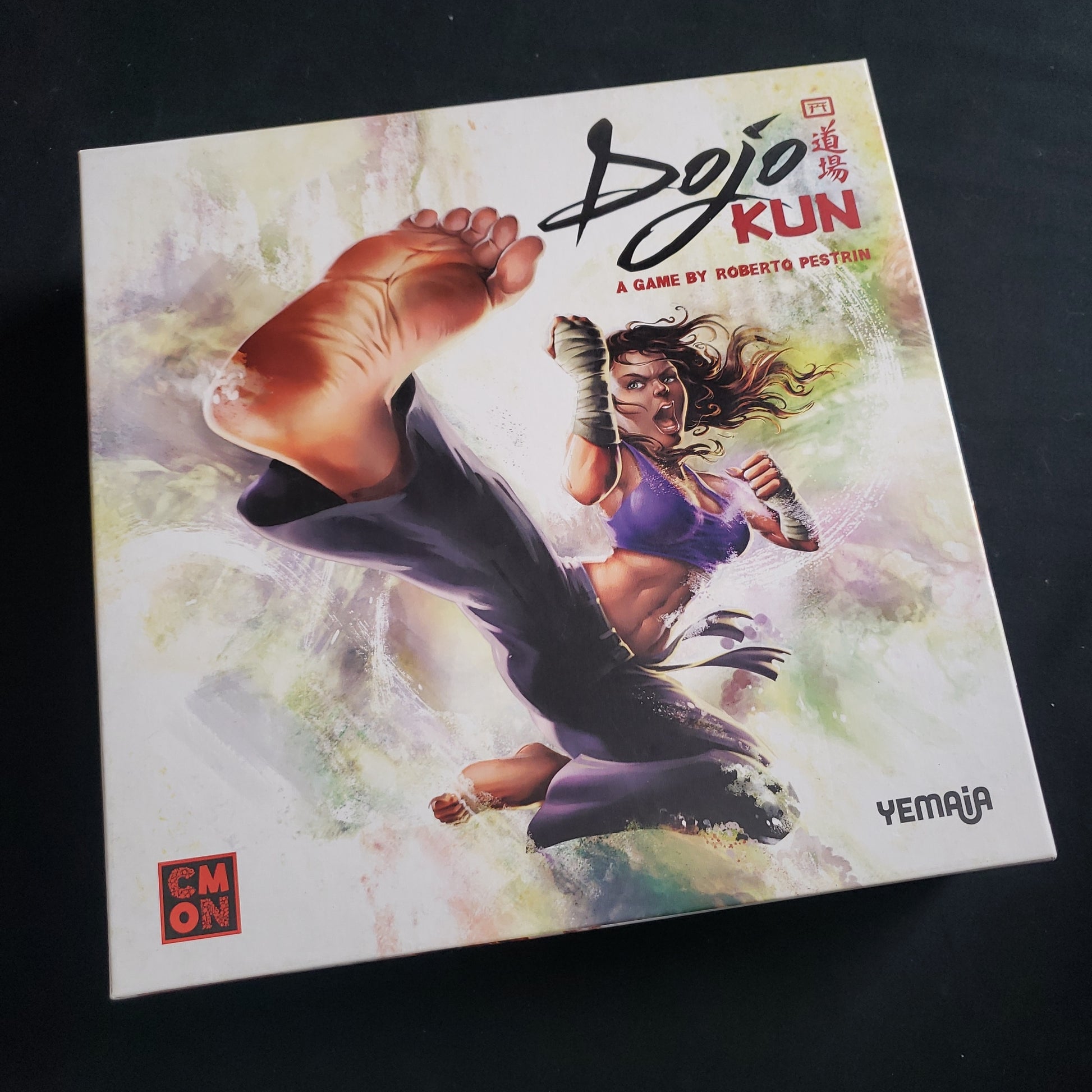 Image shows the front cover of the box of the Dojo Kun board game