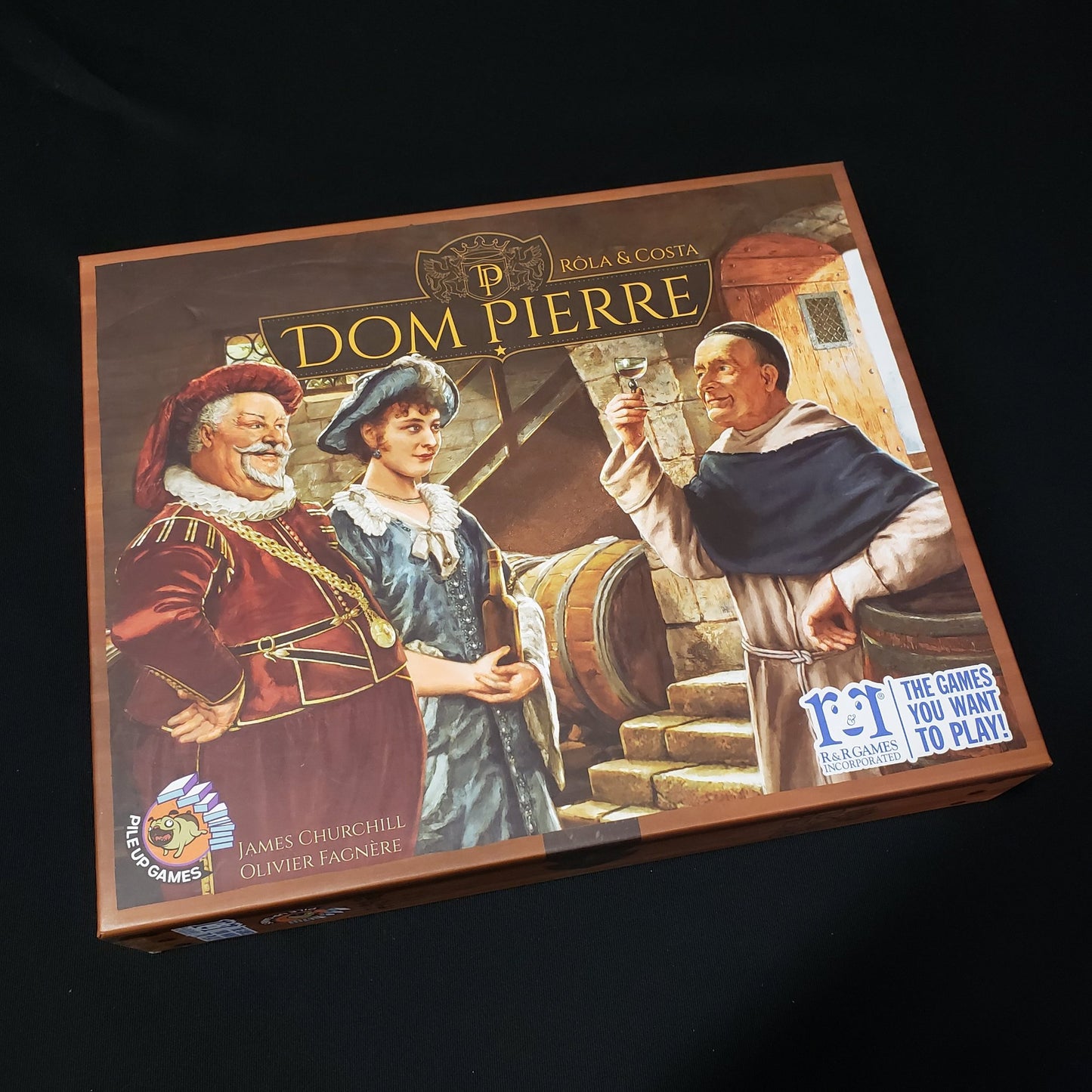 Image shows the front cover of the box of the Dom Pierre board game