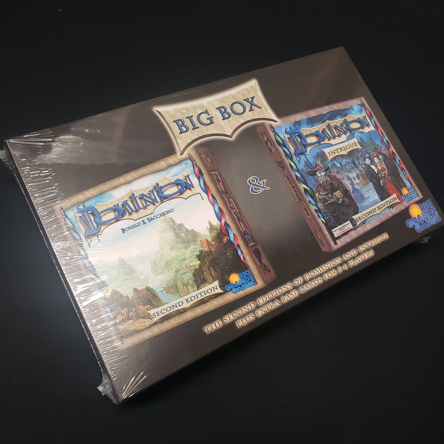 Image shows the front cover of the second edition big box for the card game Dominion