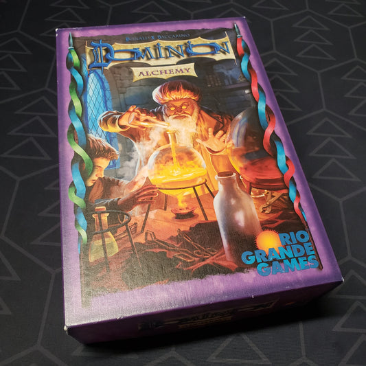 Image shows the front cover of the box of the Alchemy expansion for the card game Dominion