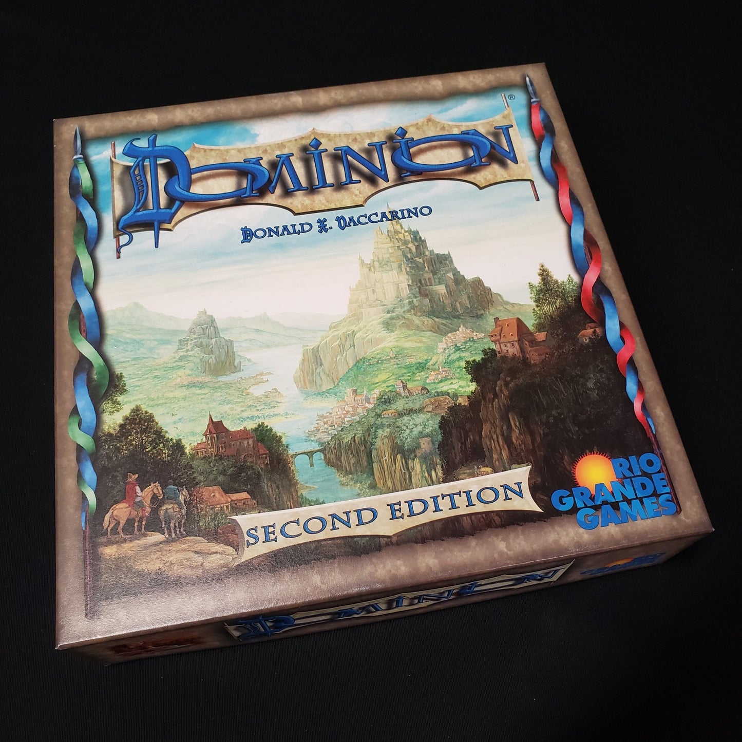 Image shows the front cover of the box of the Dominion card game