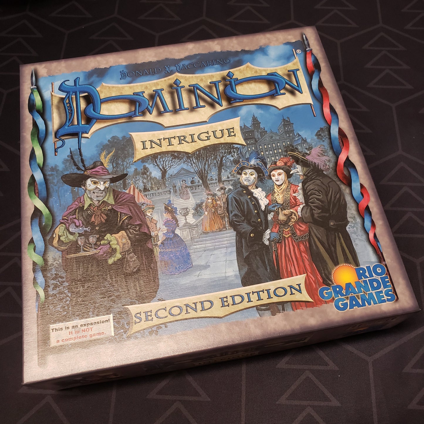 Image shows the front of the box for the Intrigue expansion for the board game Dominion: Second Edition