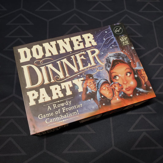 Image shows the front cover of the box of the Donner Dinner Party card game