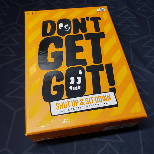Image shows the front cover of the box for the Shut Up & Sit Down Special Edition of the card game Don't Get Got!