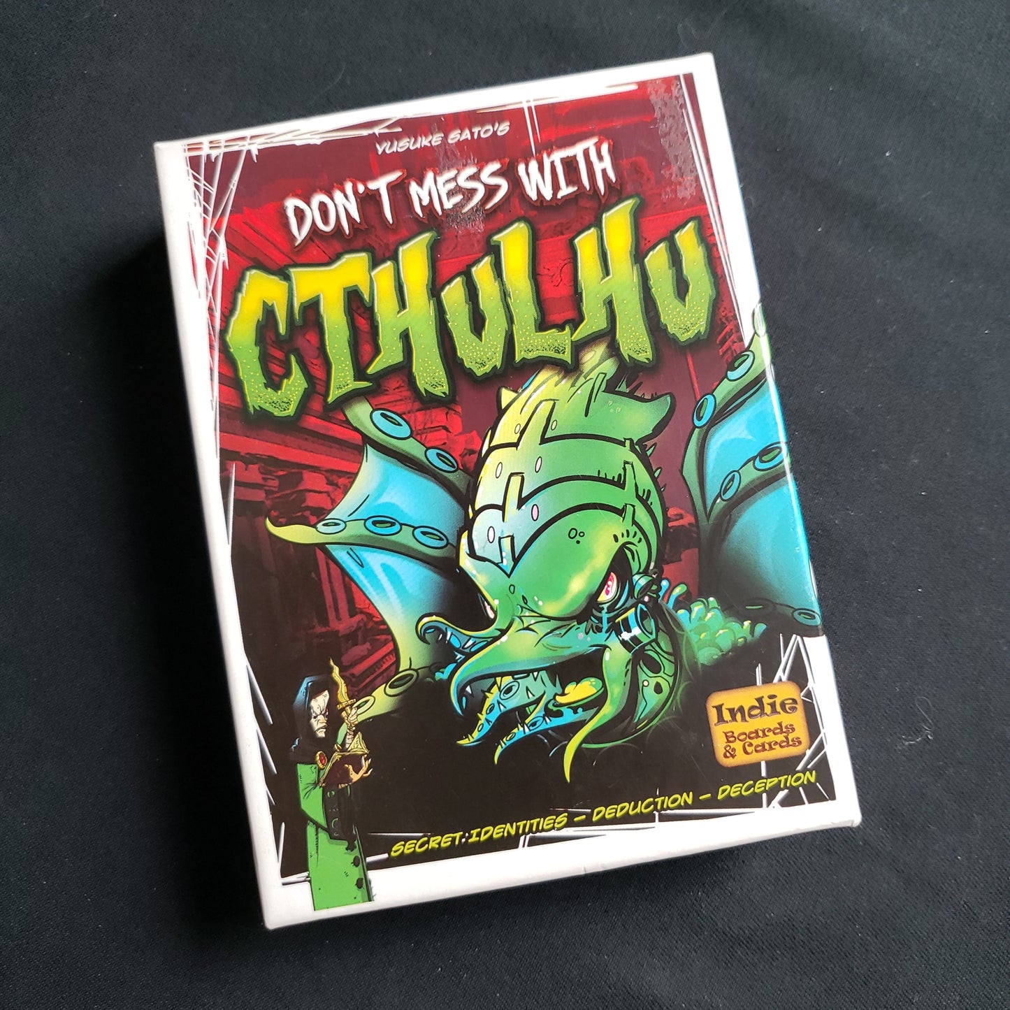 Image shows the front cover of the box of the Don't Mess With Cthulhu card game