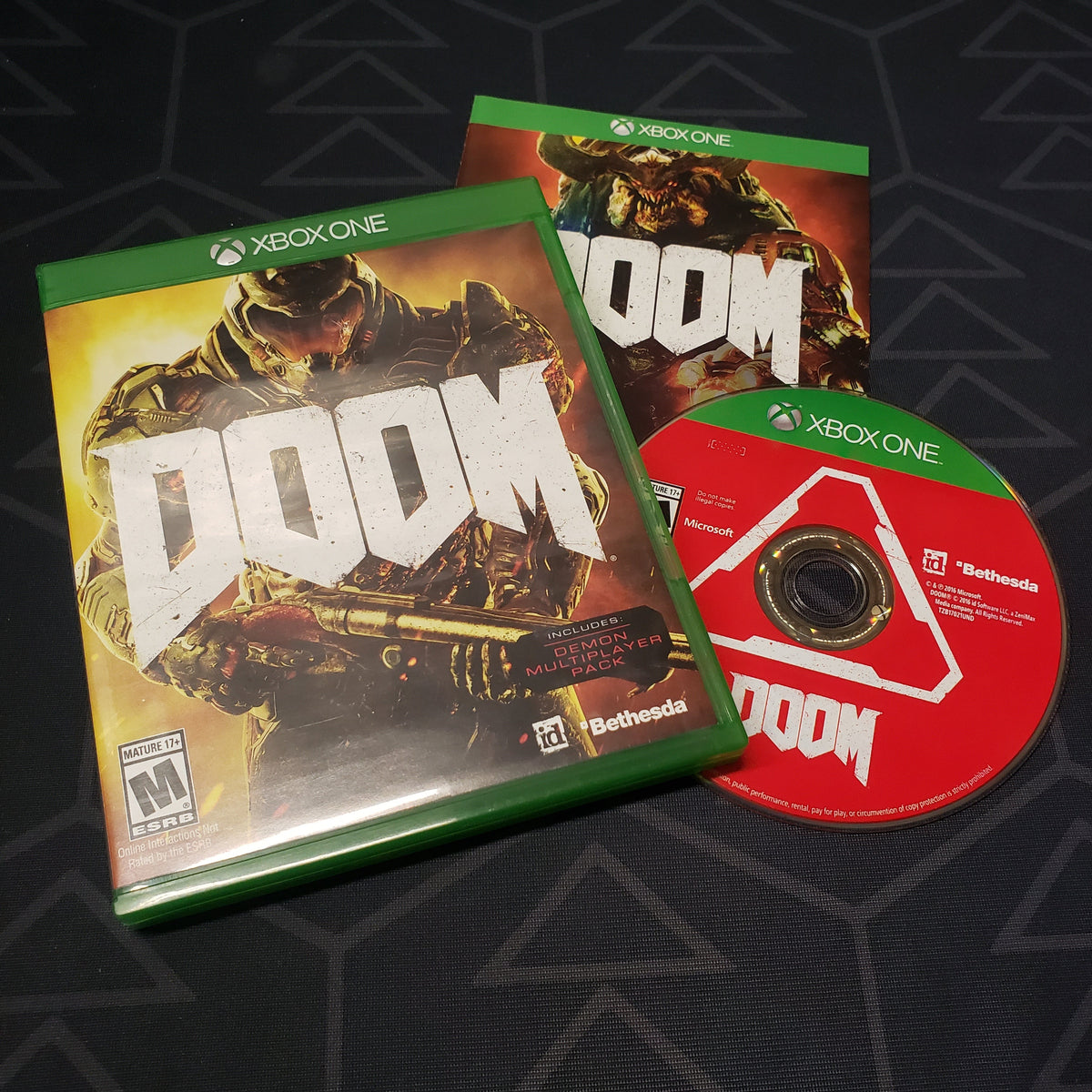 Image shows the case, manual and disc for the video game Doom for Xbox One