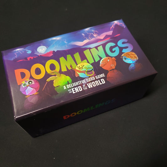 Image shows the front cover of the box of the Doomlings card game
