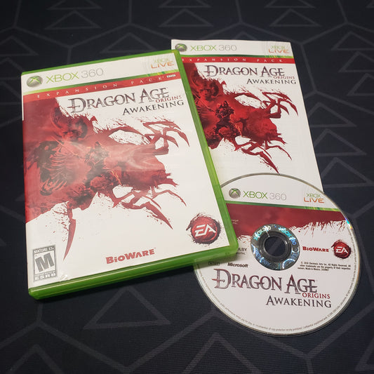 Image shows the case, manual and disc for the Awakenings Expansion pack for the video game Dragon Age: Origins for Xbox 360