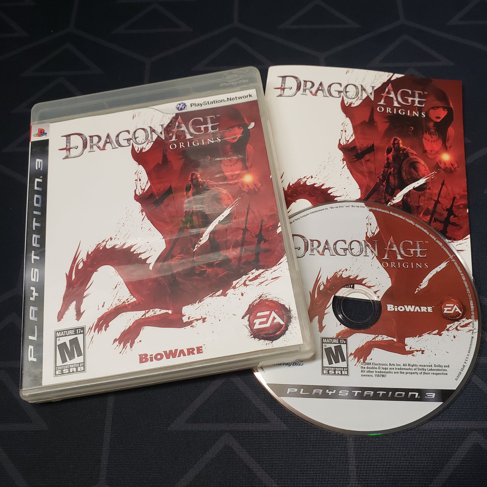 Image shows the case, manual & disc for the video game Dragon Age: Origins for Playstation 3