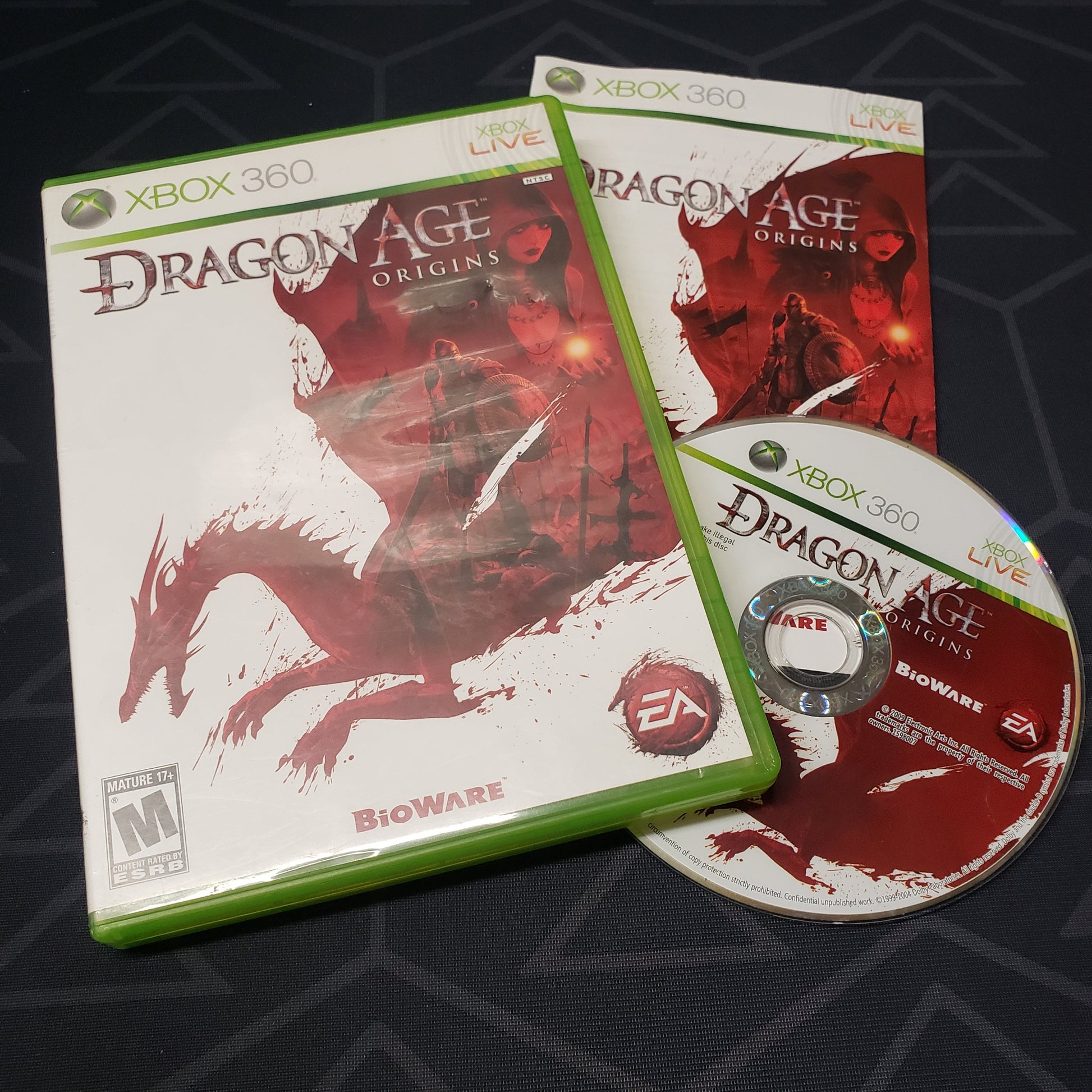 Image shows the case, manual and disc for the video game Dragon Age: Origins for Xbox 360
