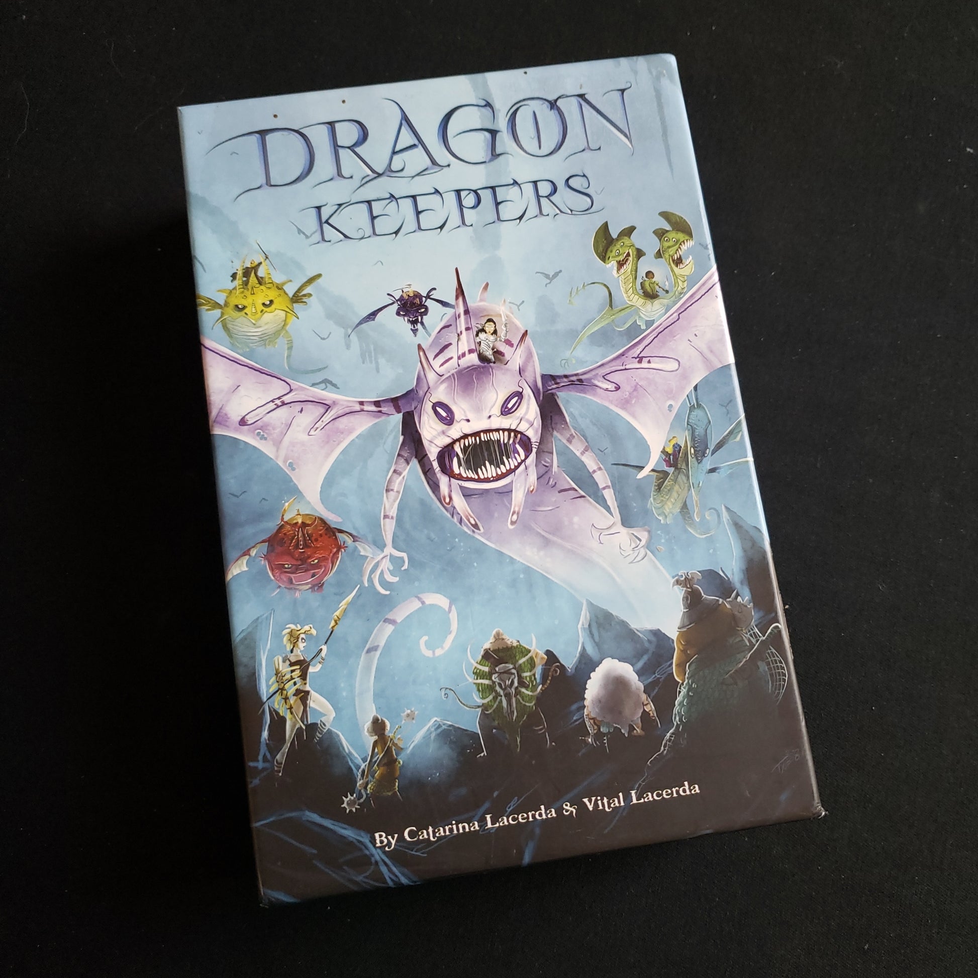 Image shows the front cover of the box of the Dragon Keepers card game