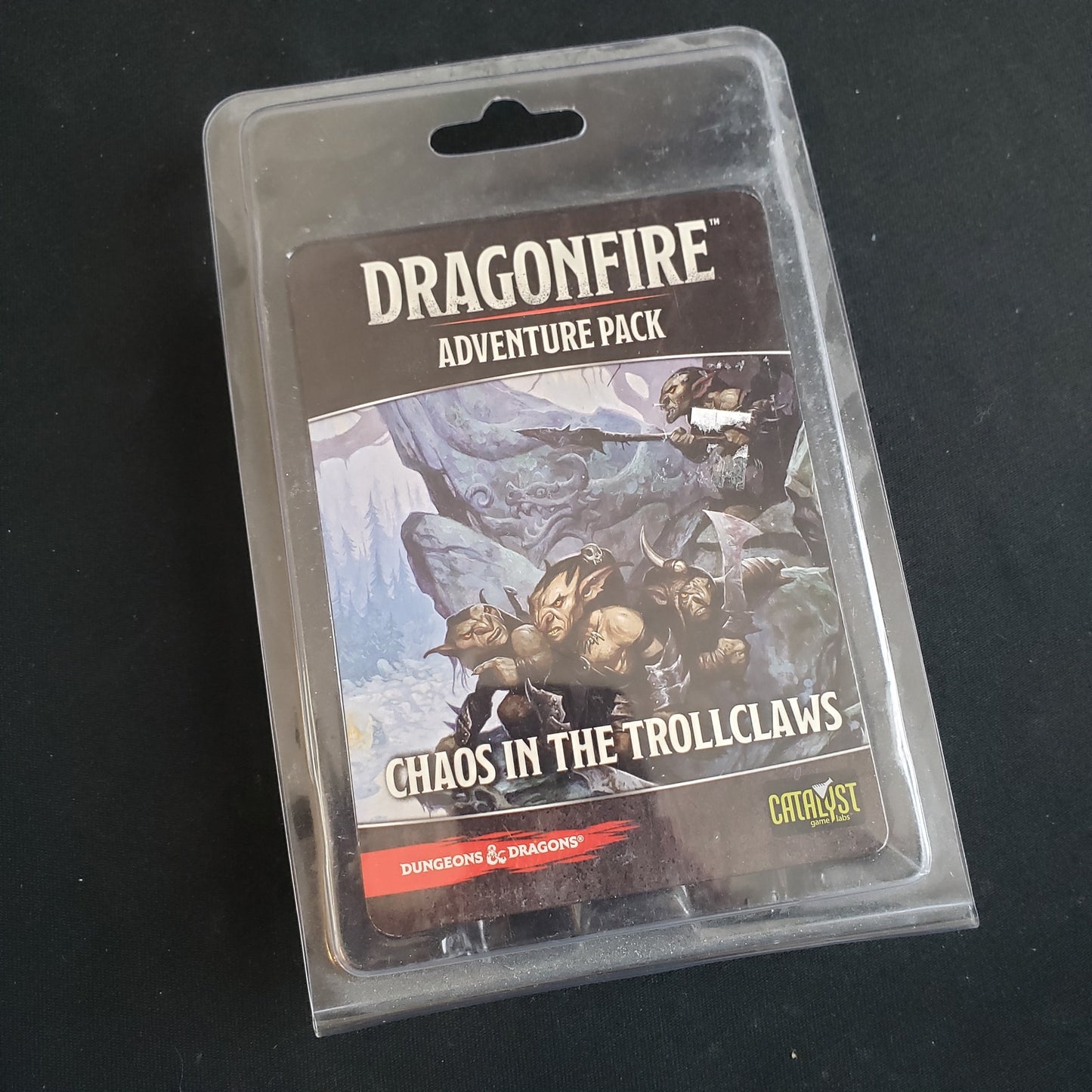 Image shows the front of the package for the Chaos in the Trollclaws Adventure Pack for the Dragonfire card game