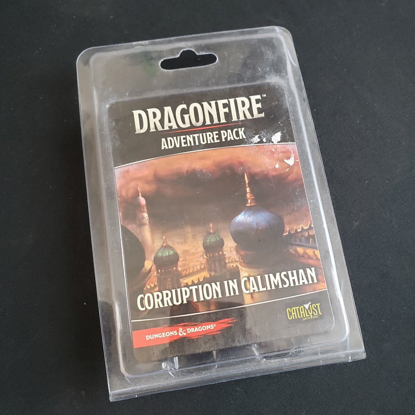 Image shows the front of the package for the Corruption in Calimshan Adventure Pack for the Dragonfire card game