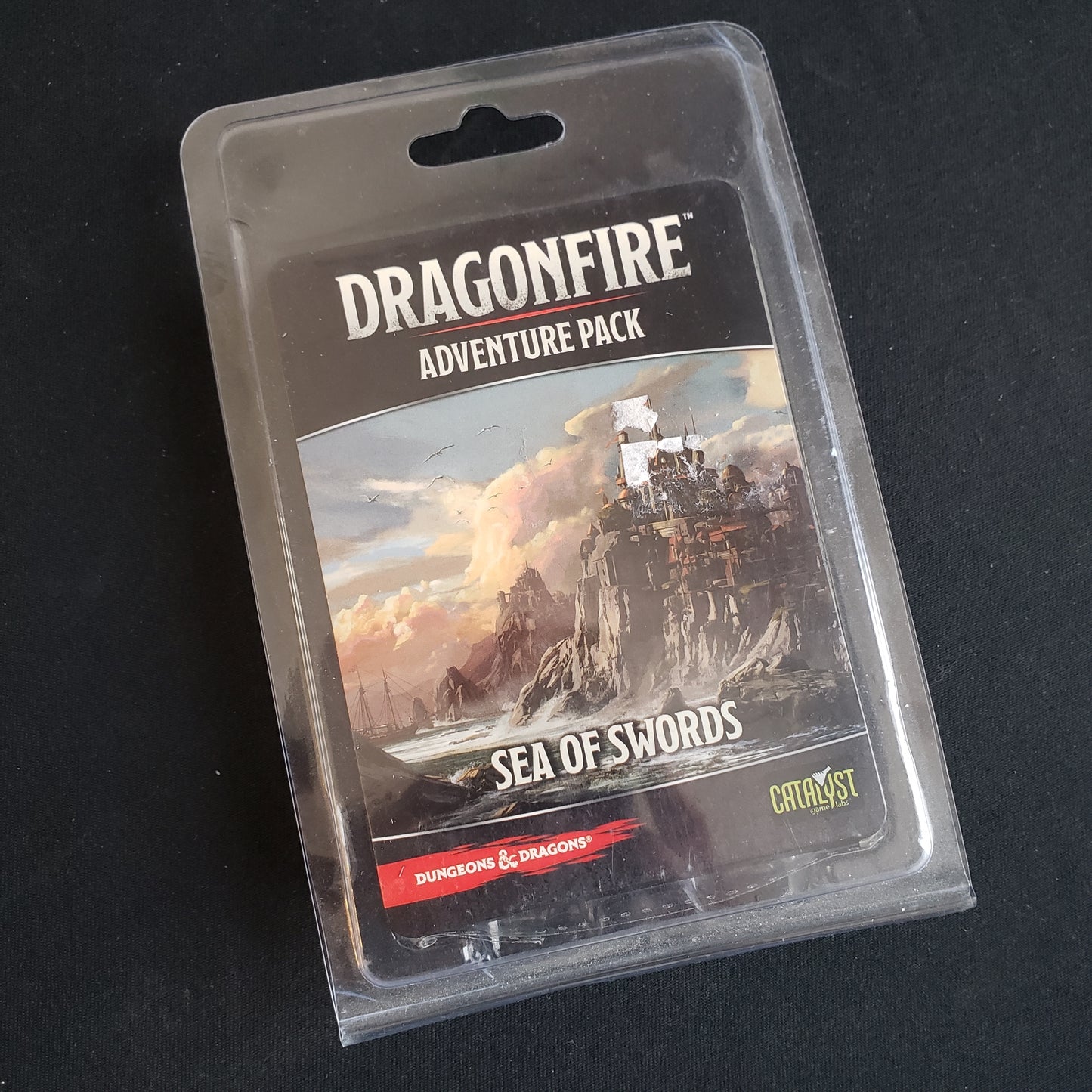 Image shows the front of the package for the Sea of Swords Adventure Pack for the Dragonfire card game