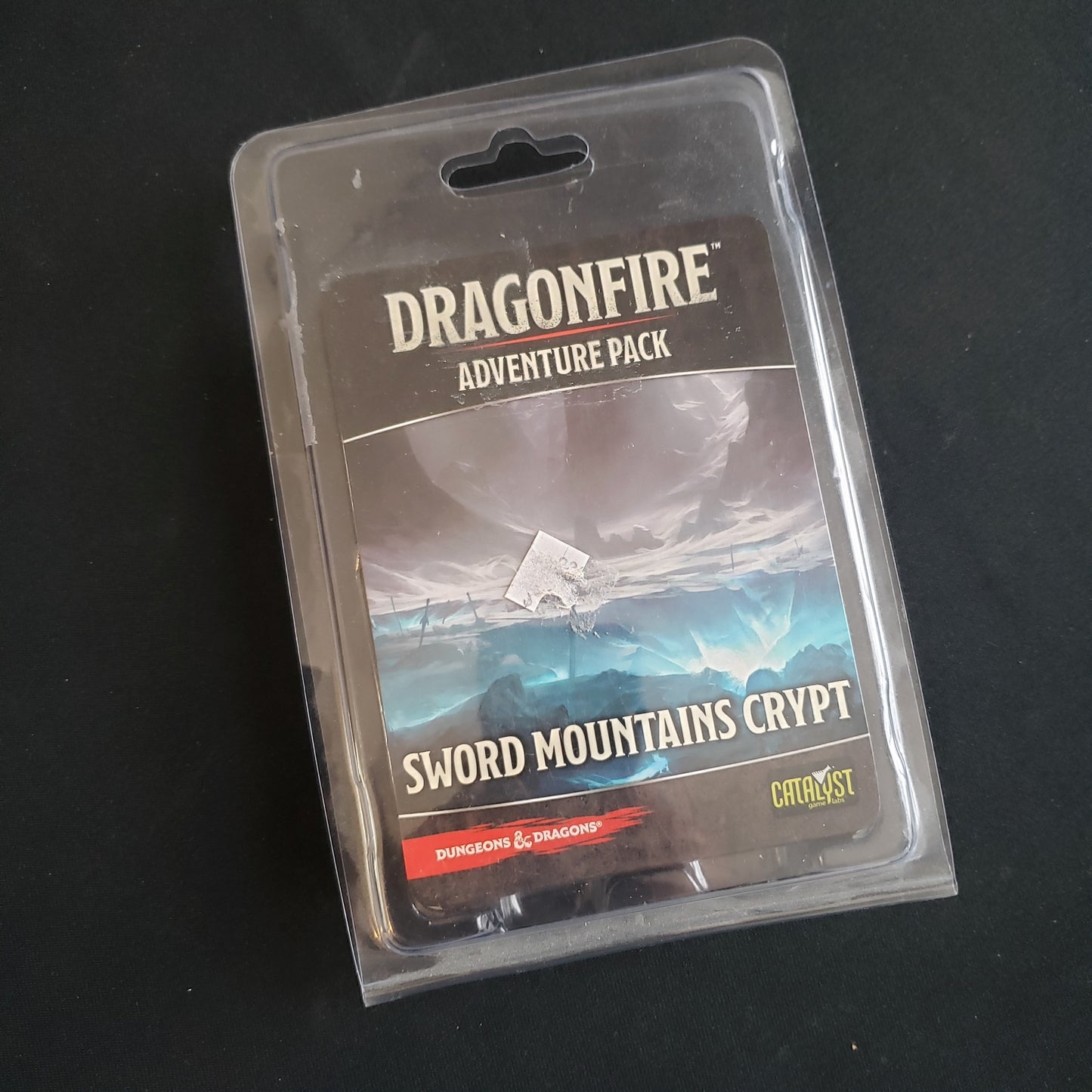 Image shows the front of the package for the Sword Mountains Crypt Adventure Pack for the Dragonfire card game