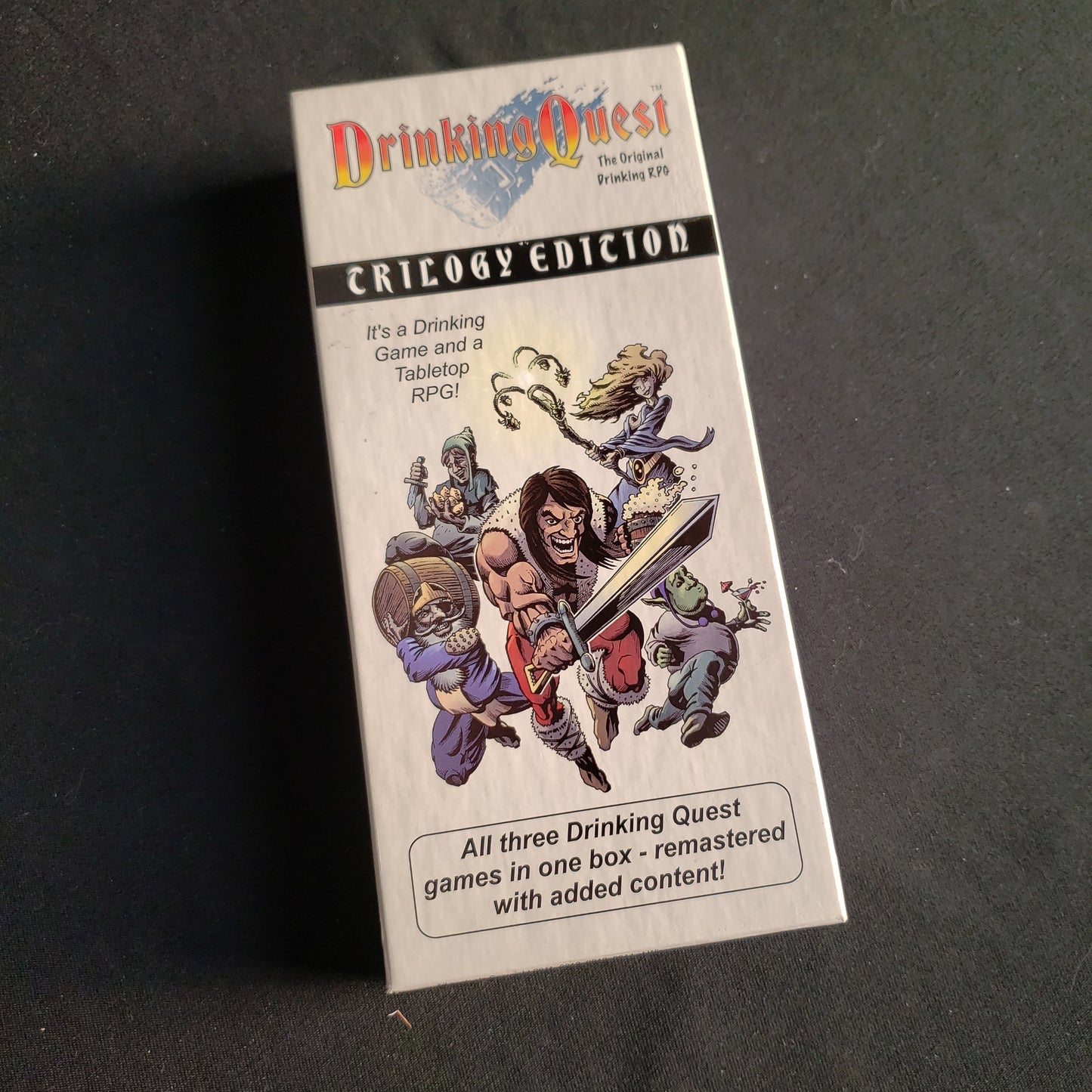 Image shows the front cover of the box of the Drinking Quest: Trilogy Edition card game