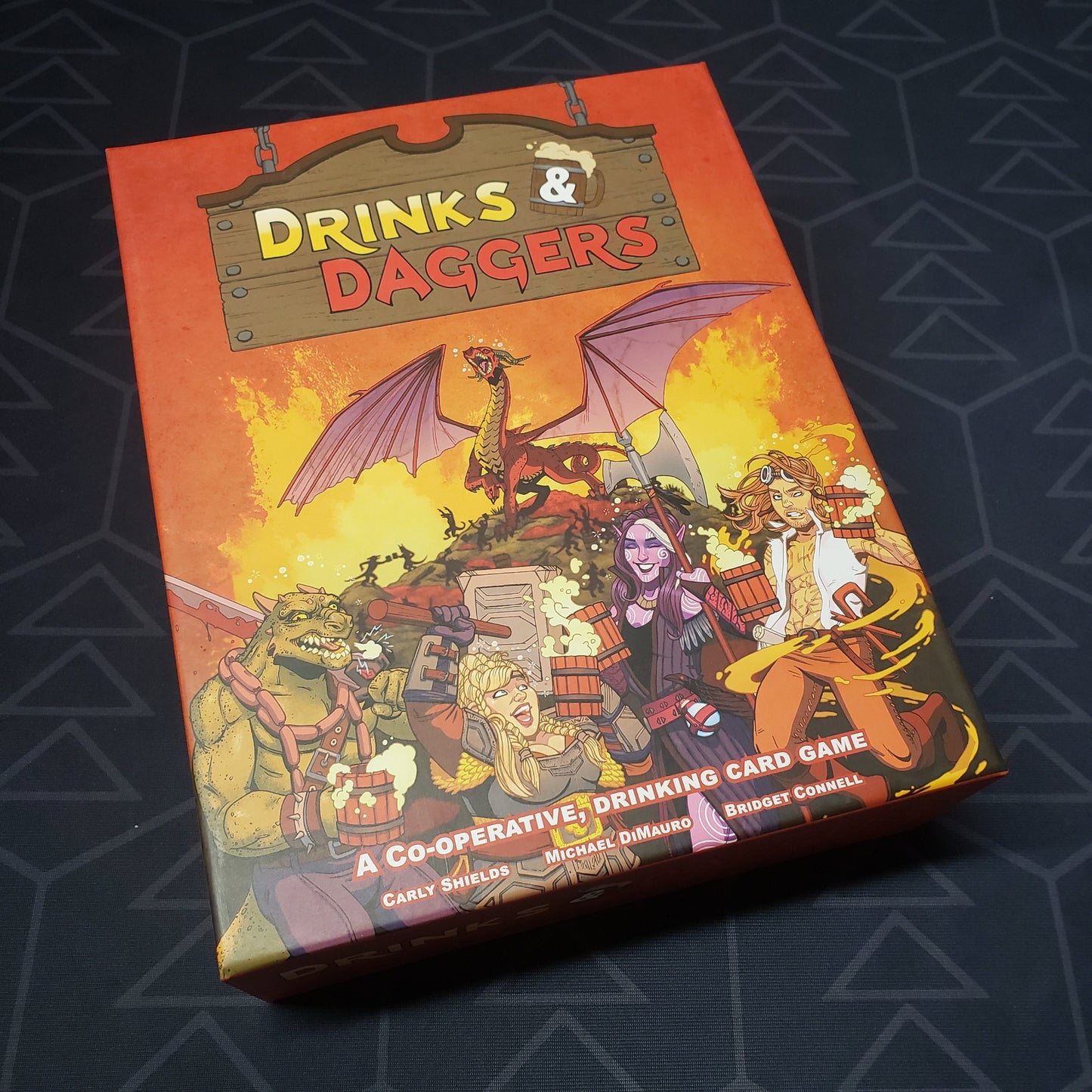 Image shows the front cover of the box for the Drinks & Daggers board game