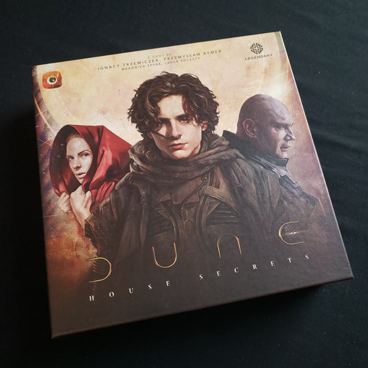 Image shows the front cover of the box of the Dune: House Secrets board game