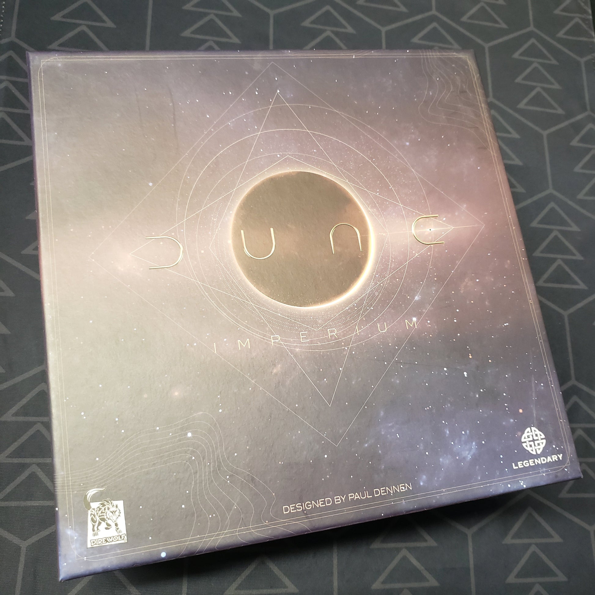 Image shows the front cover of the box of the Deluxe Upgrade Pack for the board game Dune: Imperium