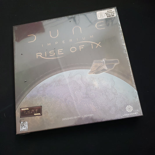 Image shows the front cover of the box of the Rise of Ix expansion for the board game Dune: Imperium