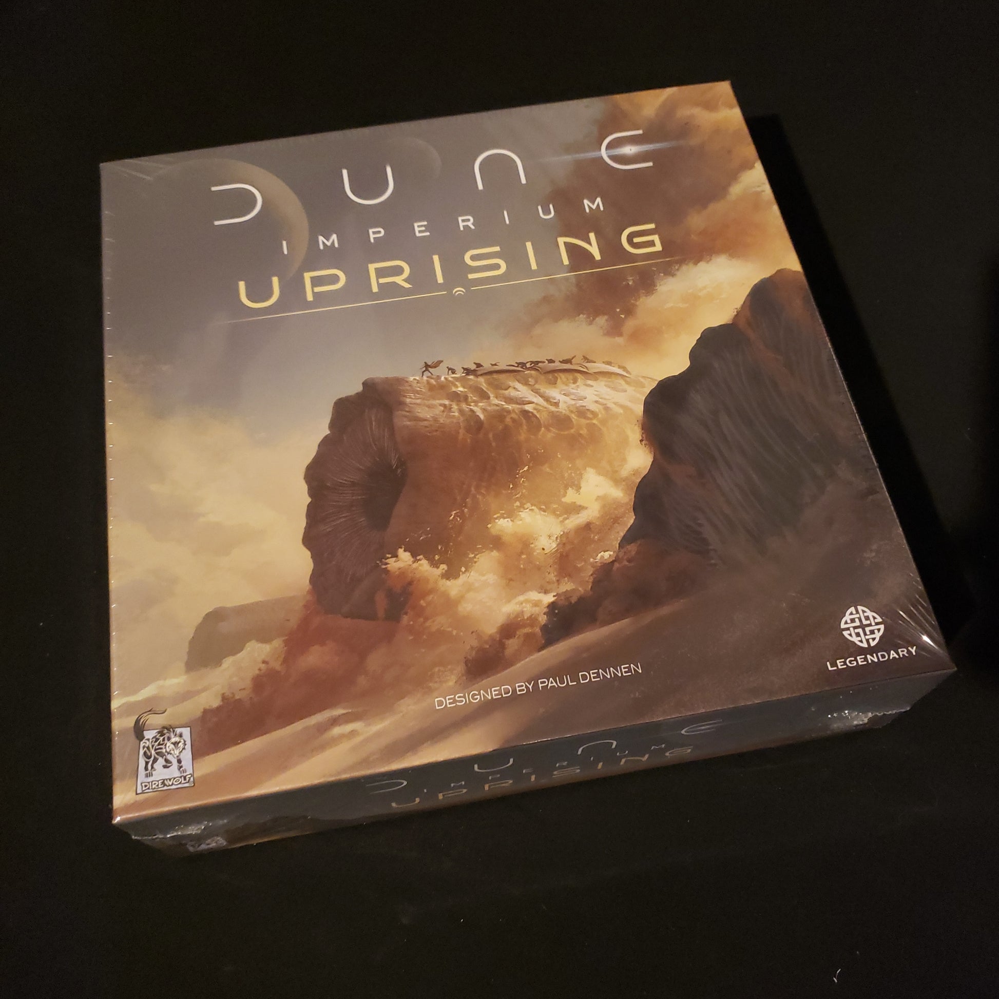 Image shows the front cover of the box of the Dune Imperium: Uprising board game