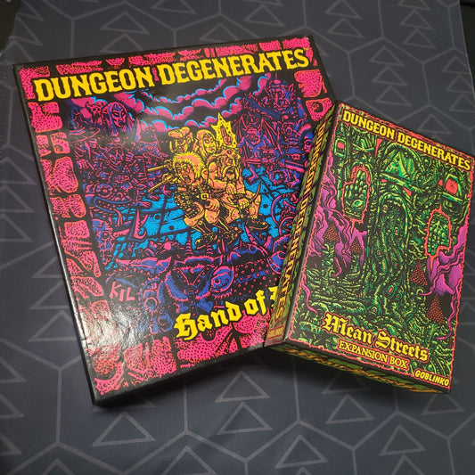 Image shows the front cover of the box for the Dungeon Degenerates: Hand of Doom board game along with the Mean Streets expansion box
