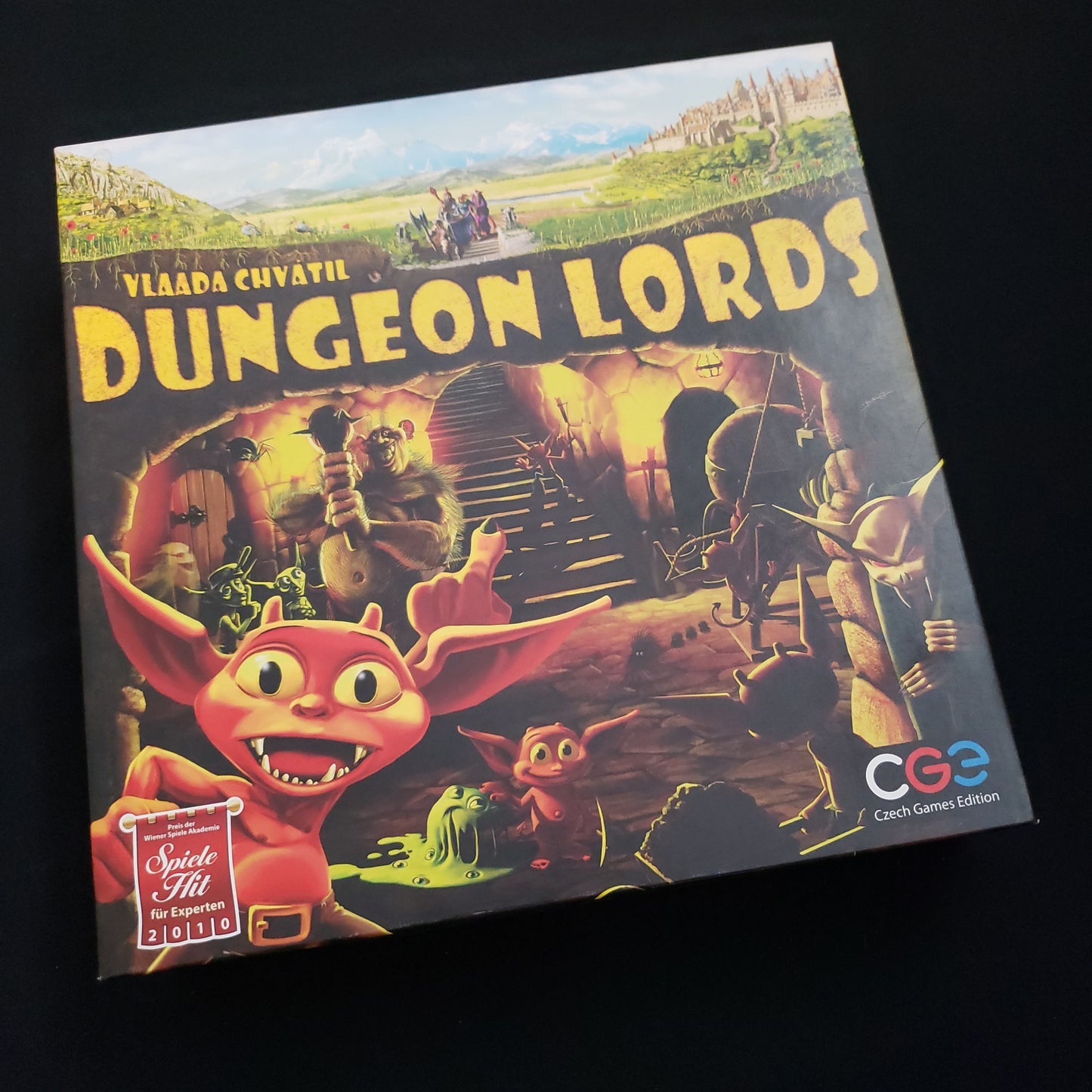 Image shows the front cover of the box of the Dungeon Lords board game