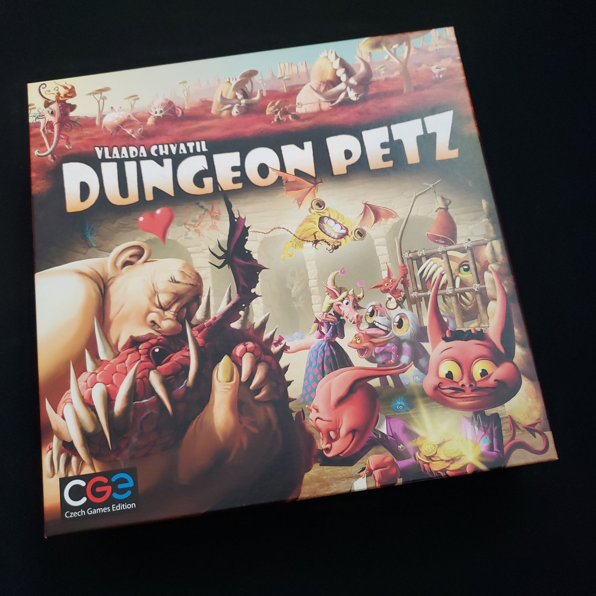 Image shows the front cover of the box of the Dungeon Petz board game