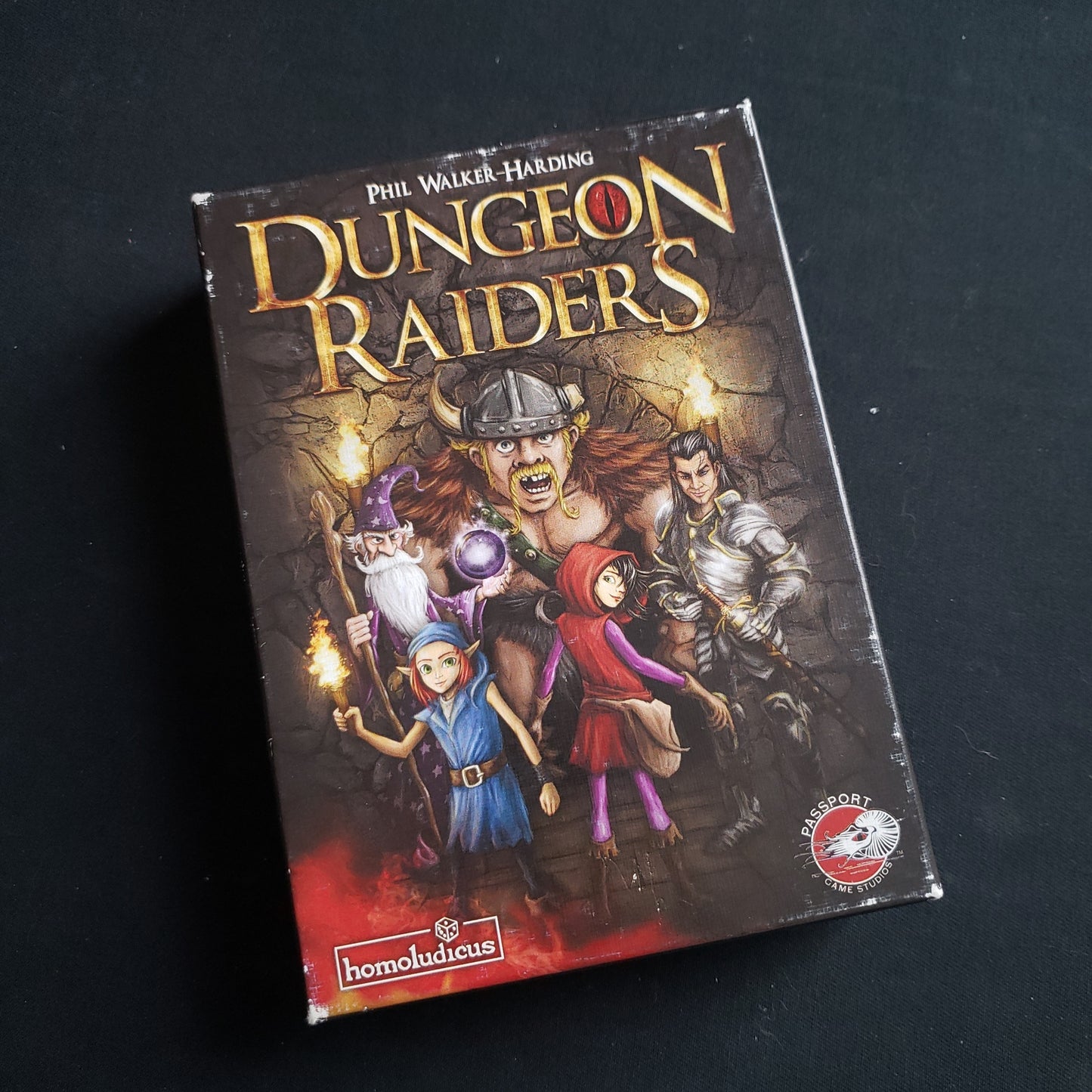 Image shows the front cover of the box of the Dungeon Raiders card game