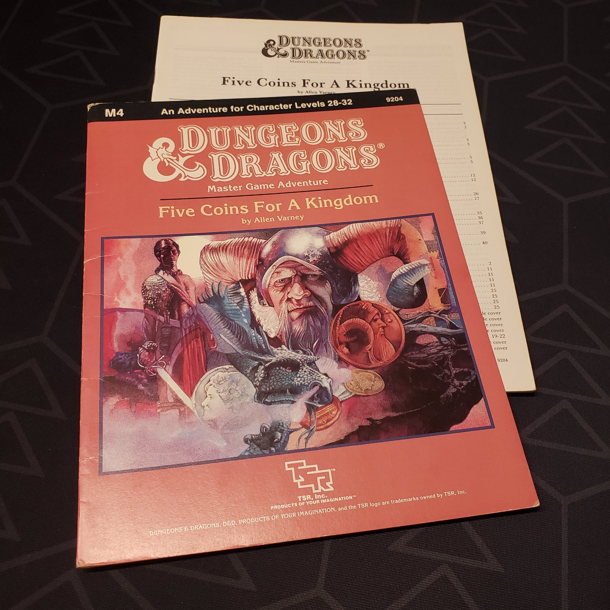 Image shows the front cover of the folio for the Five Coins for a Kingdom adventure module for the roleplaying game Dungeons & Dragons: First Edition, with the booklet fanned out