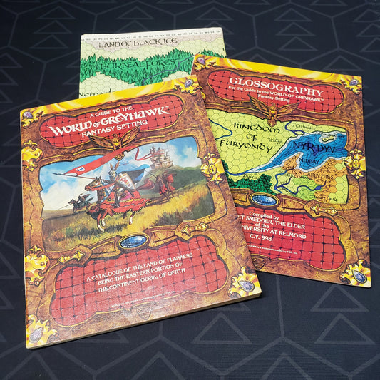 Image shows the front covers of the World of Greyhawk & Glossographyr booklets and half of the Greyhawk world map for the roleplaying game Dungeons & Dragons: First Edition