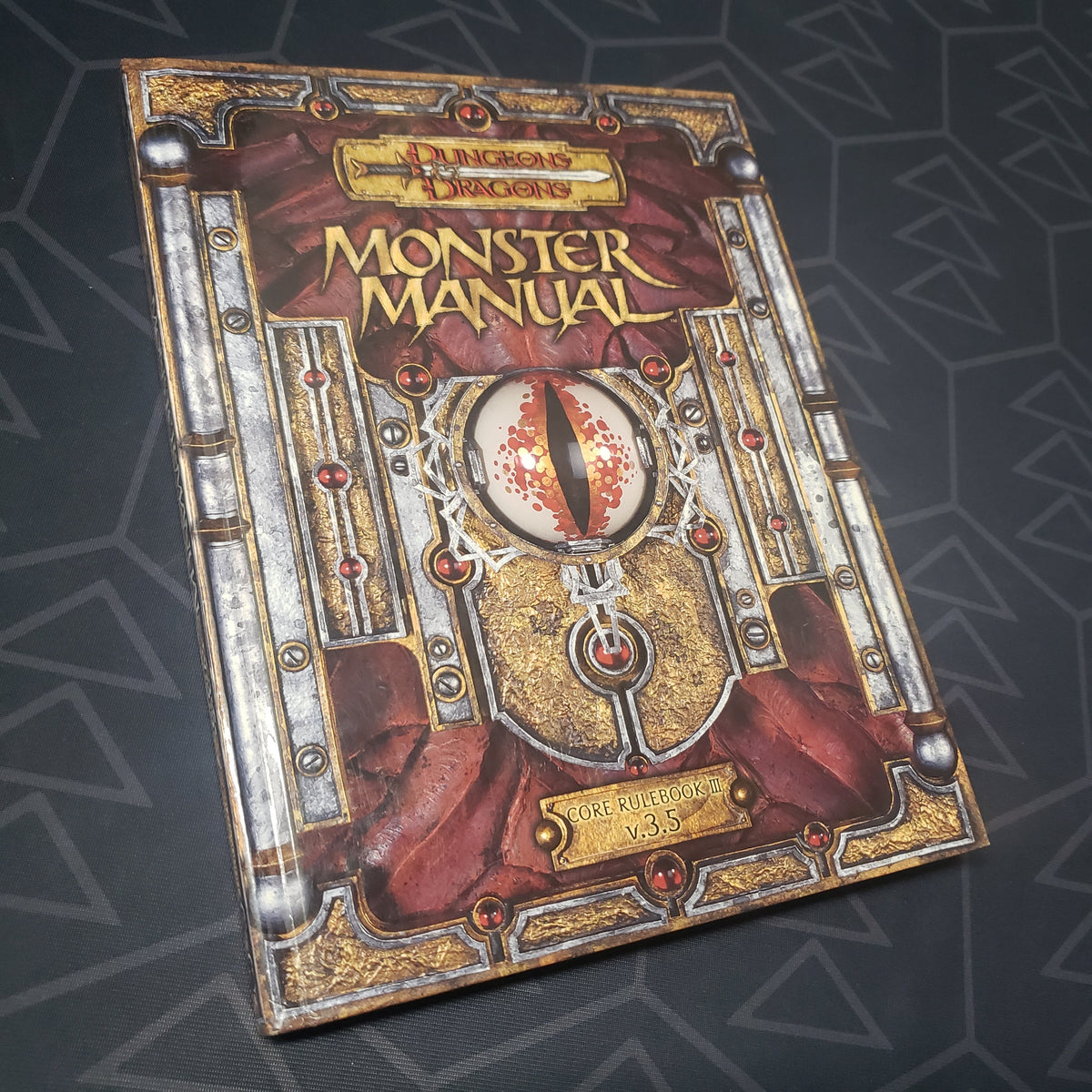 Image shows the front cover of the Monster Manual book for the roleplaying game Dungeons & Dragons 3.5E