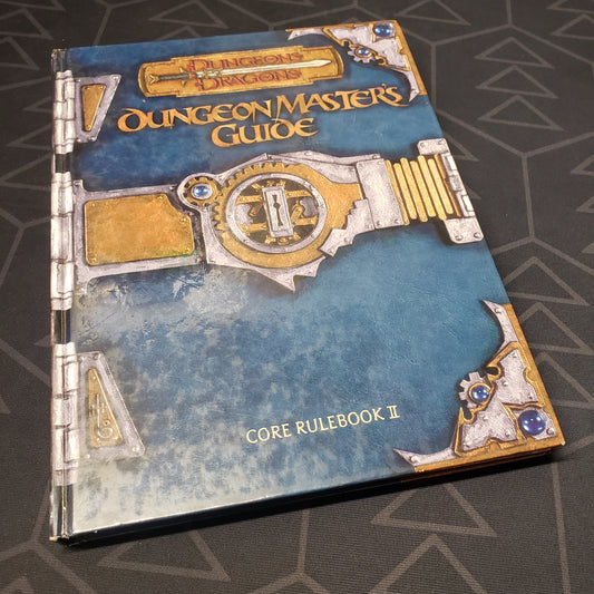 Image shows the front cover of the Dungeon Master's Guide book for the roleplaying game Dungeons & Dragons: Third Edition