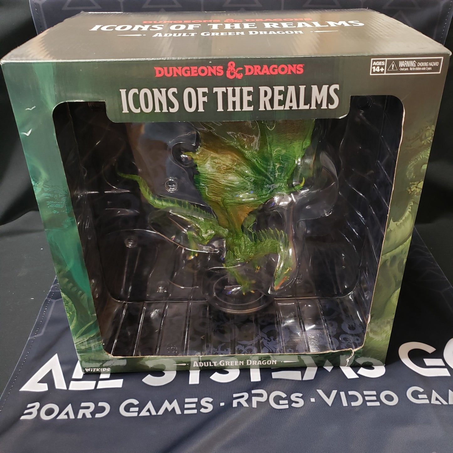 Image shows the front cover of the Icons of the Realms: Adult Green Dragon miniature box for the roleplaying game Dungeons & Dragons
