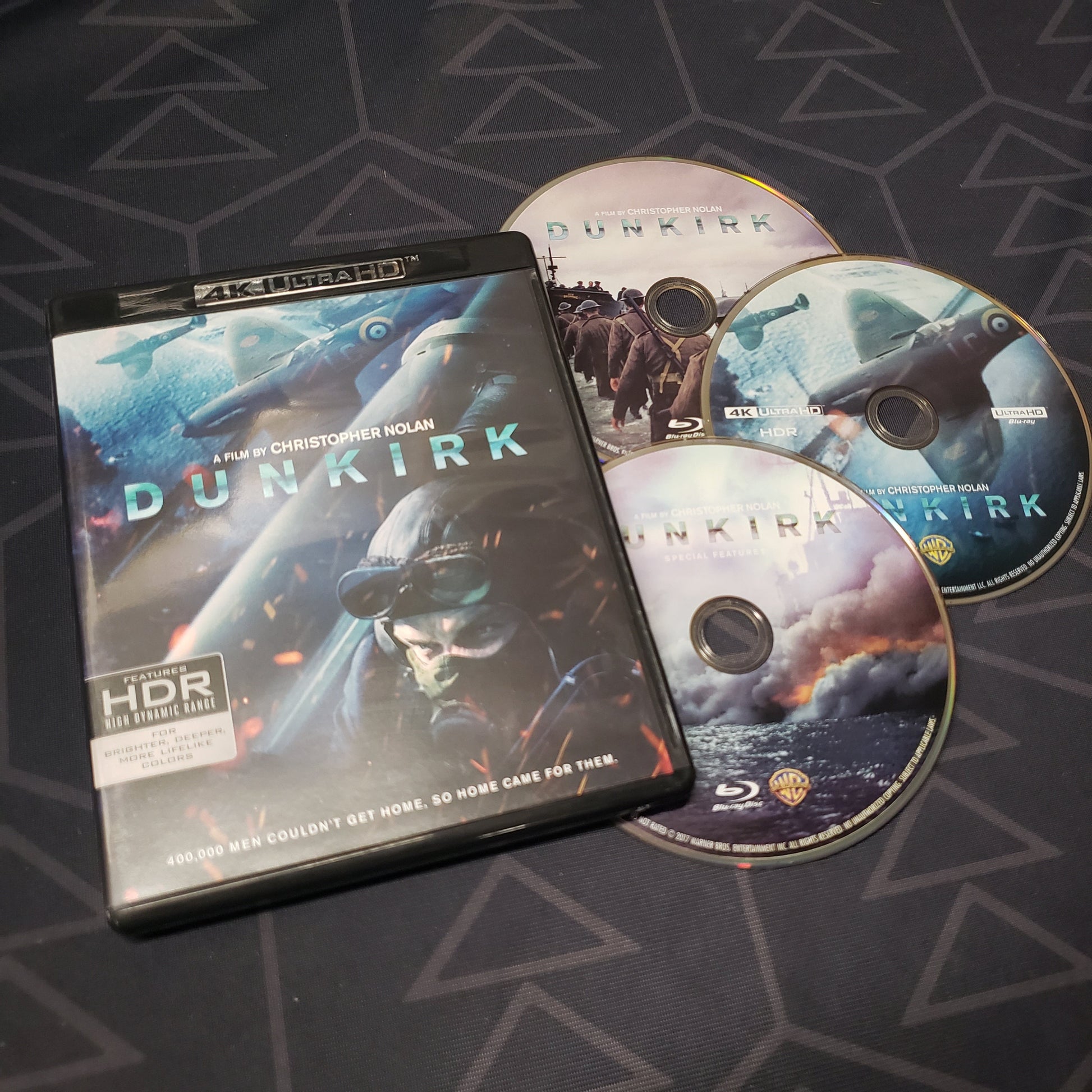 Image shows the case & three discs for the movie Dunkirk on 4K UHD & Blu-Ray