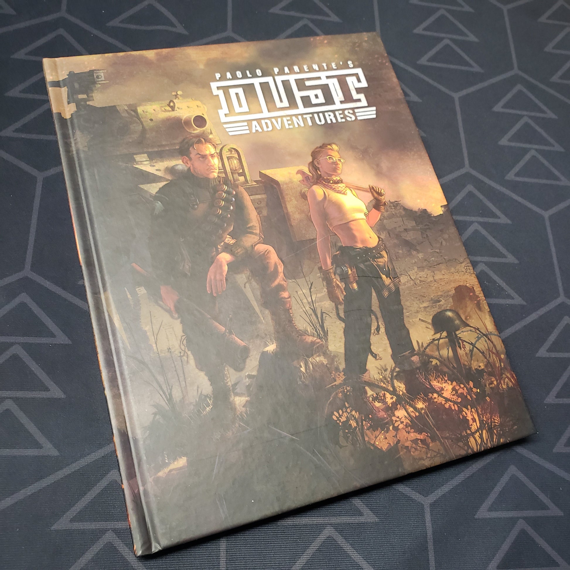 Image shows the front cover of the core rulebook for the roleplaying game DUST Adventures