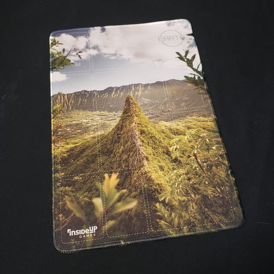 Image shows a playmat featuring the Green Peak artwork for the board game Earth