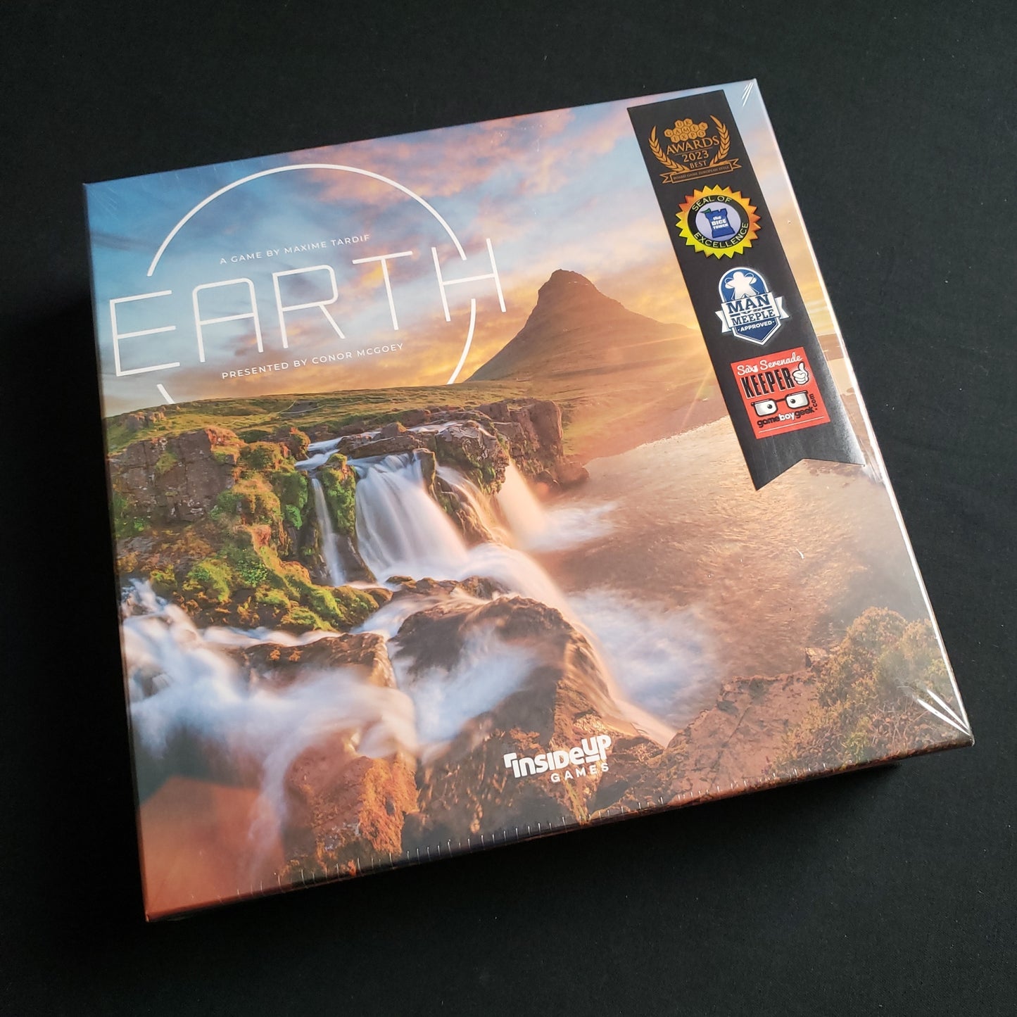 Image shows the front cover of the box of the board game Earth
