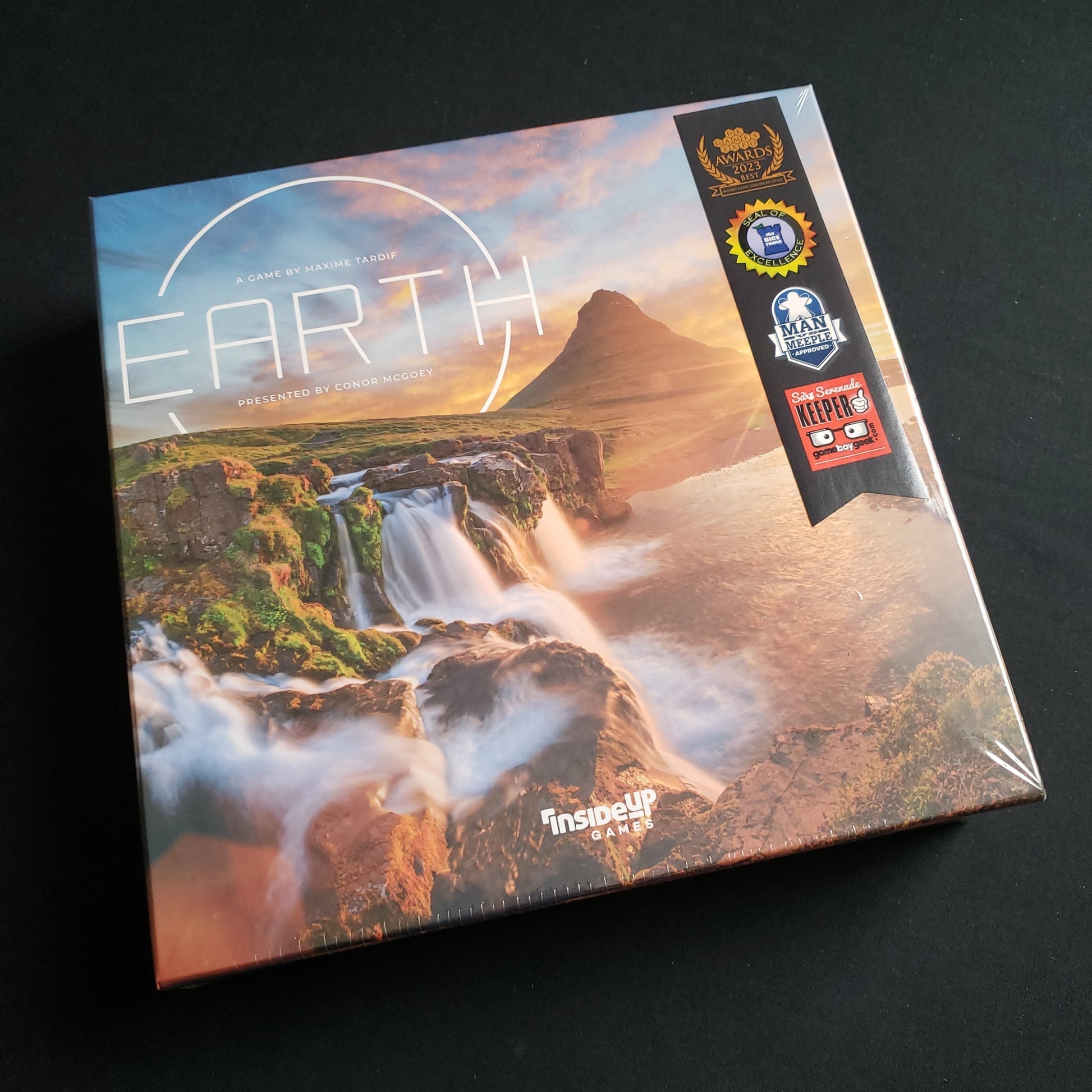 Image shows the front cover of the box of the board game Earth
