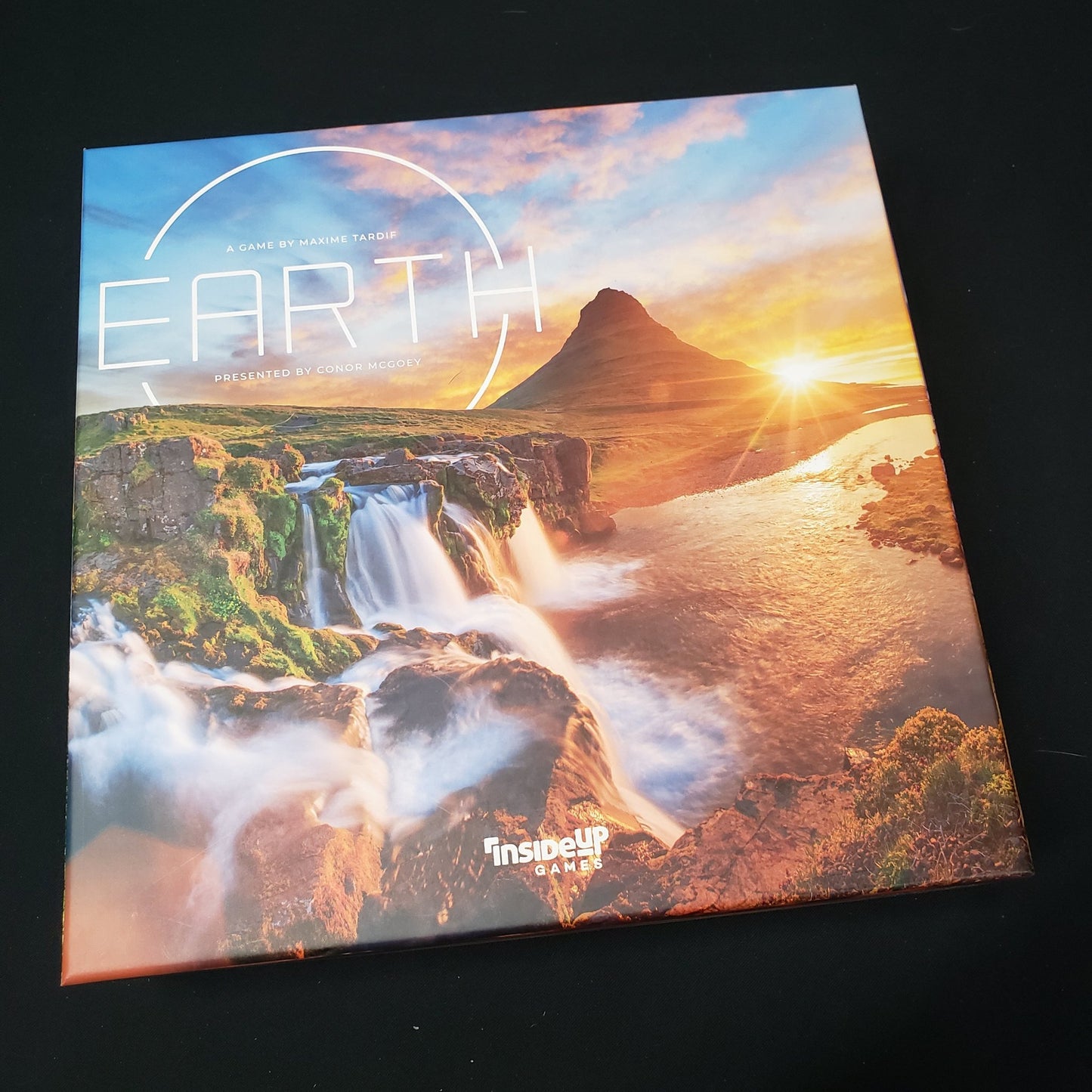 Image shows the front cover of the box of the board game Earth