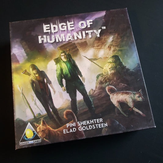 Image shows the front cover of the box of the Edge of Humanity board game