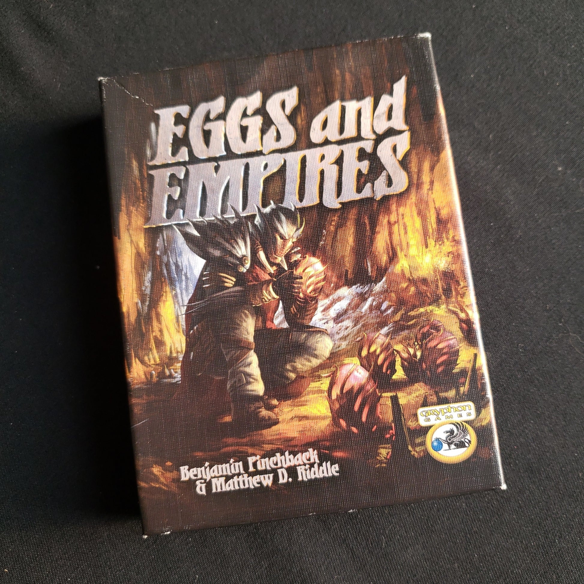 Image shows the front cover of the box of the Eggs & Empires card game