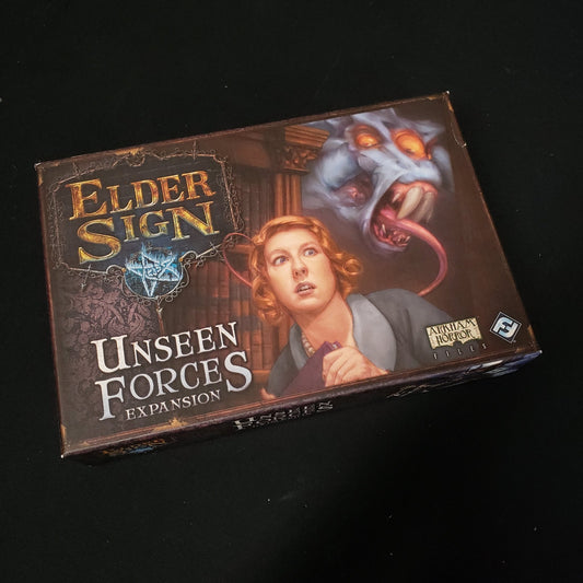 Image shows the front cover of the box for the Unseen Forces expansion from the board game Elder Sign
