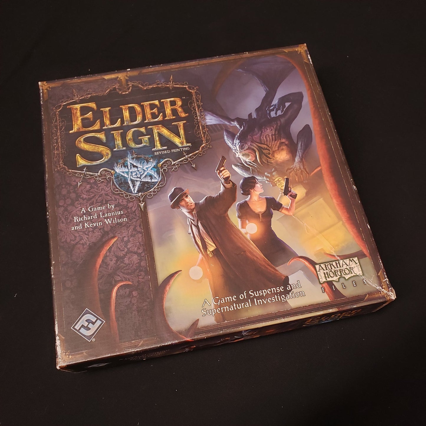 Image shows the front cover of the box of the Elder Sign board game