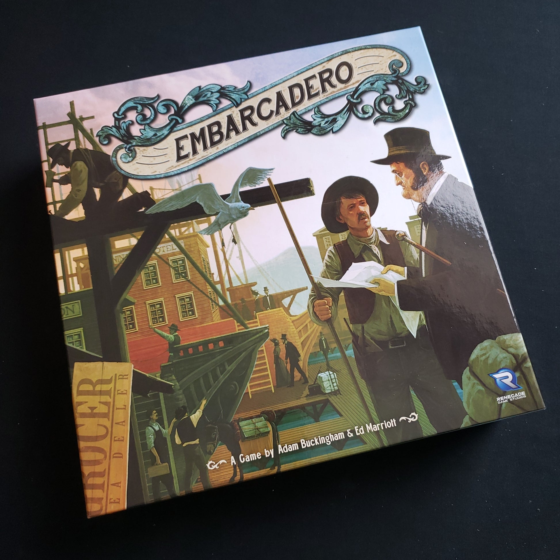Image shows the front cover of the box of the Embarcadero board game