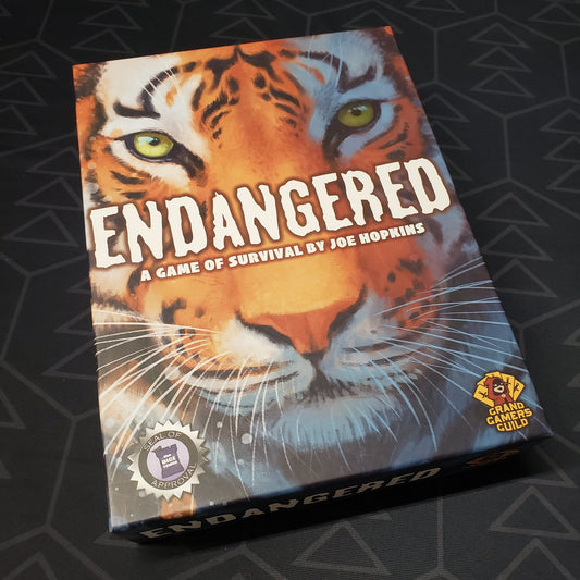 Image shows the front cover of the box of the Endangered board game