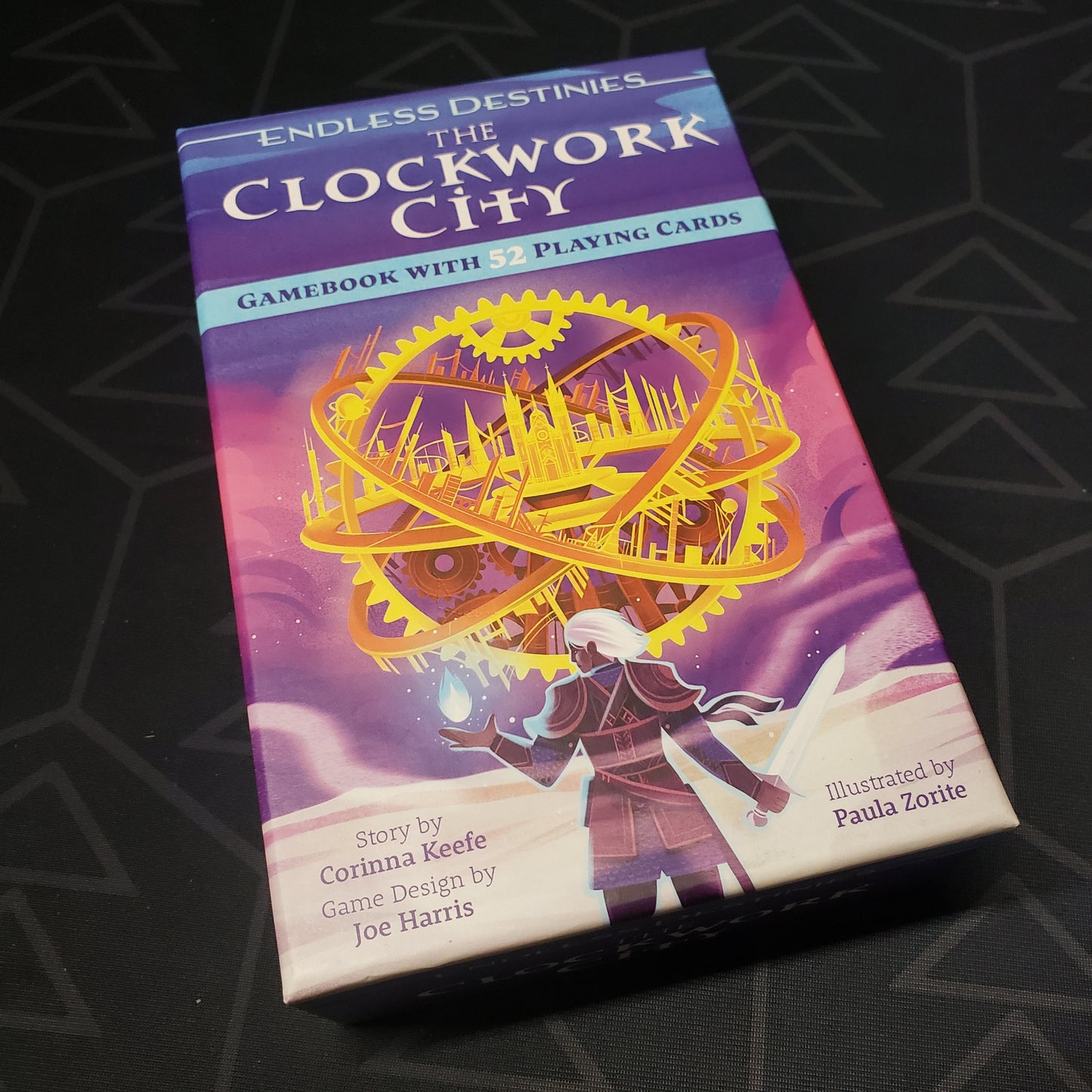 Image shows the front cover of the box of the card game Endless Destinies: The Clockwork City