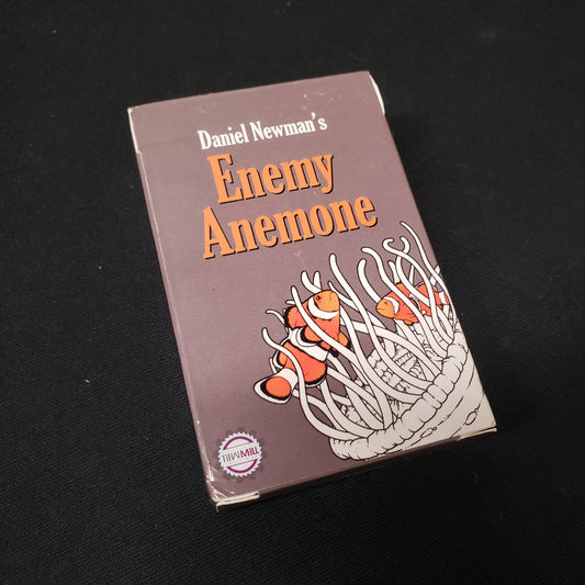 Image shows the front cover of the box of the Enemy Anemone card game