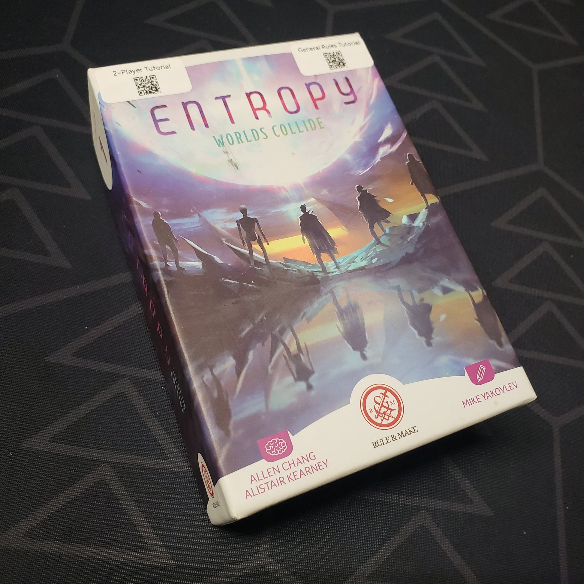 Image shows the front cover of the box for the Entropy: Worlds Collide card game